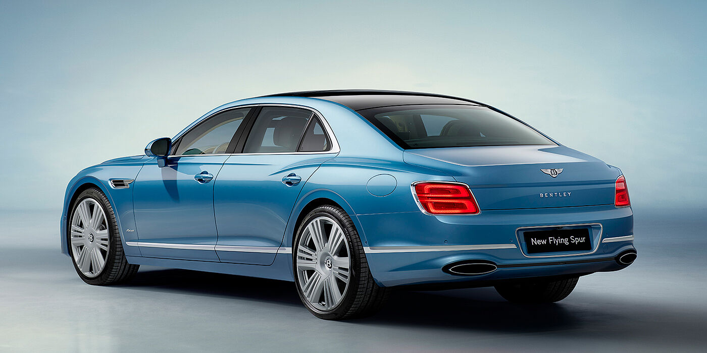 Bentley Kuwait New Bentley Flying Spur Azure sedan rear view in Light windsor blue by Mulliner paint with 22 inch Azure wheels and chrome exterior details