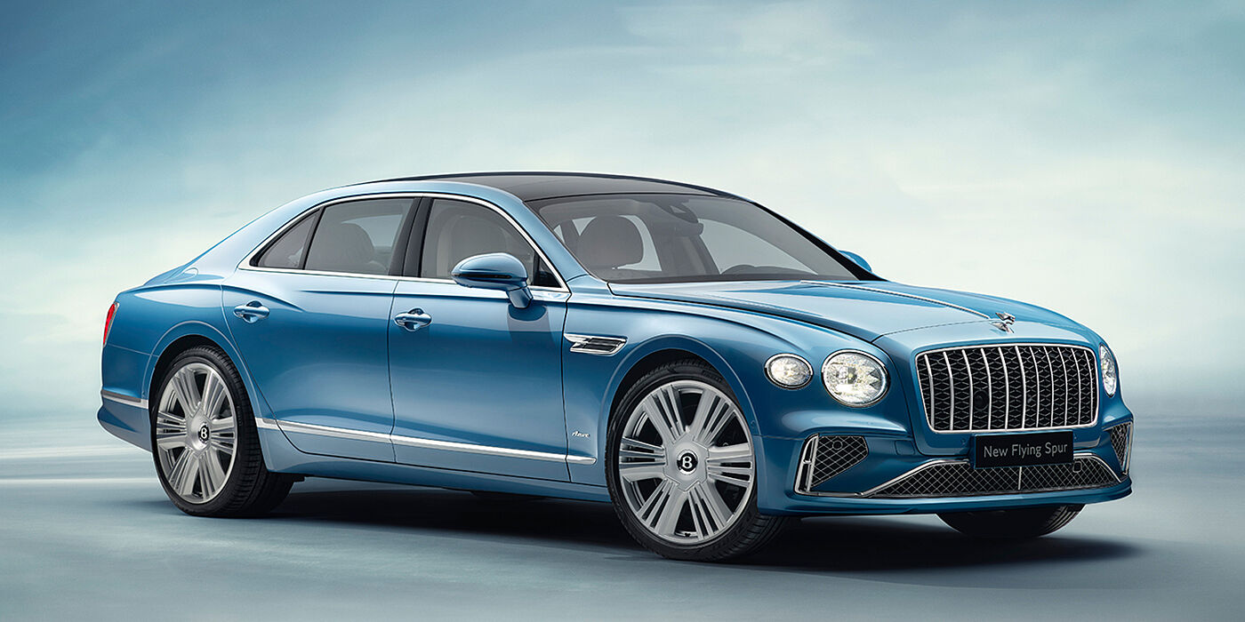 Bentley Kuwait New Bentley Flying Spur Azure sedan front view in Light windsor blue by Mulliner paint with 22 inch Azure wheels and chrome exterior details