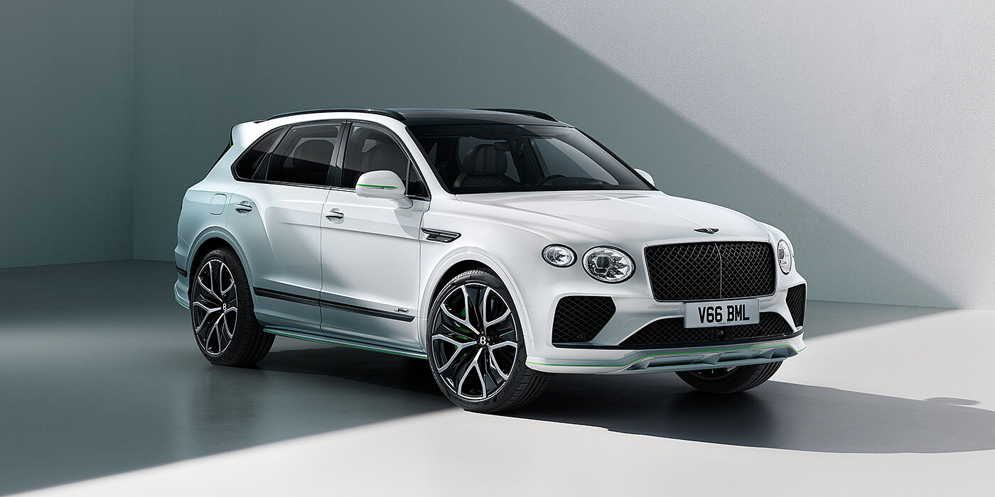 Bentley Kuwait Bentley Bentayga Speed SUV front three quarter in Snow Quartz Pearlescent by Mulliner white paint against a grey wall