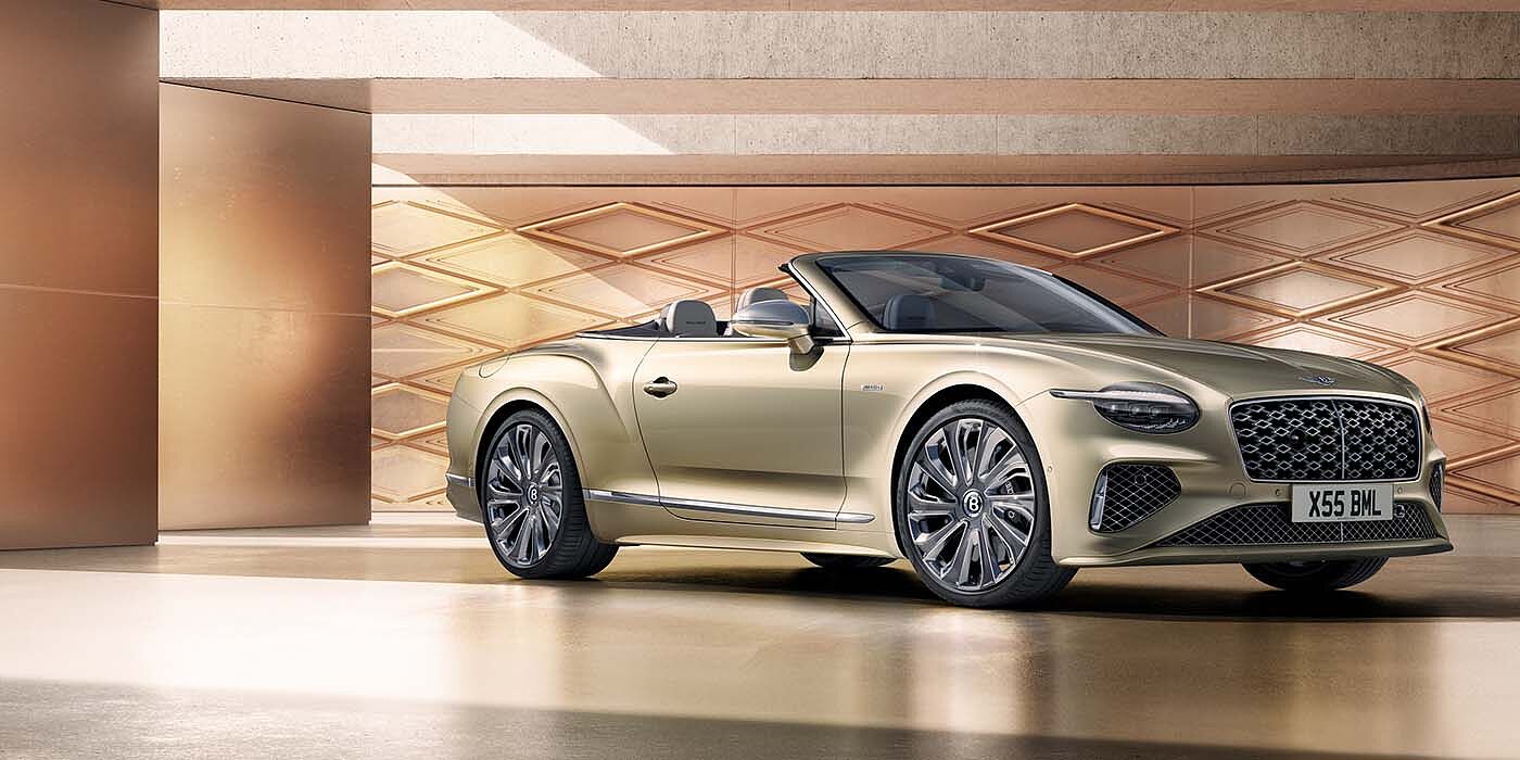 Bentley Kuwait Bentley New Continental GTC Mulliner V8 hybrid front three quarters in Patina paint