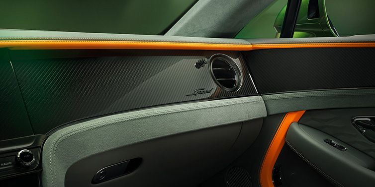 Bentley Kuwait Bentley Continental GT Speed coupe front interior dash detail with high gloss carbon fibre veneer surrounded by Mandarin by Mulliner and Gravity Grey hides