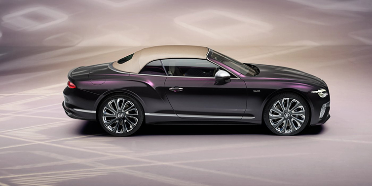 Bentley Kuwait Bentley Continental GTC Mulliner convertible in profile with hood up, in Tanzanite Purple paint and 22 inch Mulliner painted and polished wheels