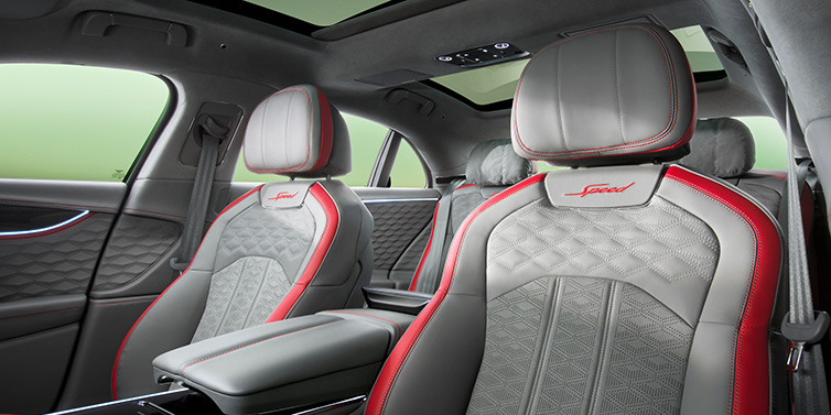 Bentley Kuwait Bentley Flying Spur Speed sedan interior showing front and rear seats in Hotspur red and Gravity Grey hides, with Speed seat emblems