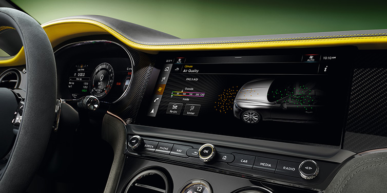 Bentley Kuwait Bentley Continental GTC Speed convertible front interior centre console with MMI screen showing Air Quality visualisation surrounded by Cyber Yellow by Mulliner and Gravity Grey hides and high gloss carbon fibre veneer