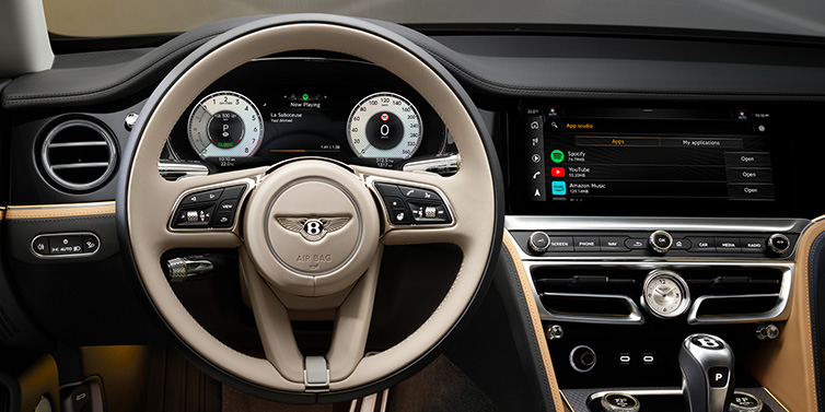 Bentley Kuwait Bentley Flying Spur Mulliner sedan front interior detail of steering wheel and driver screens surrounded by Linen and Beluga black hides