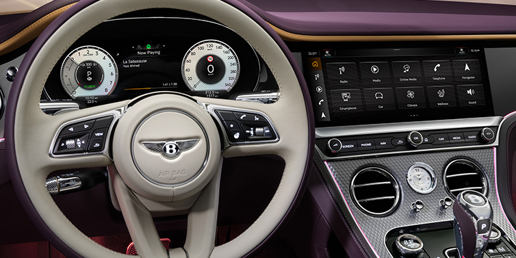 Bentley Kuwait Bentley Continental GTC Mulliner convertible steering wheel and drivers screens surrounded by Damson purple and Linen hides